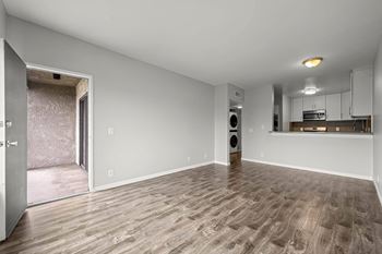 A room with a wooden floor and a speaker in it.